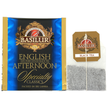 Saszetka herbaty Basilur English Afternoon w złoto-niebieskiej kopercie i torebka z logo Basilur.