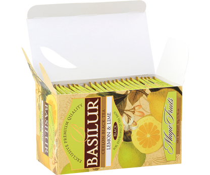 Otwarte pudełko herbaty Basilur Lemon & Lime z rzędem żółto-zielonych saszetek.