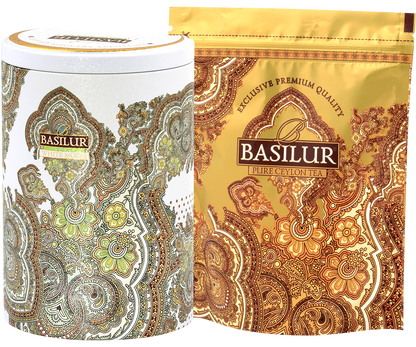 Zestaw herbaty Basilur White Moon – elegancka puszka i złote opakowanie z liśćmi herbaty.