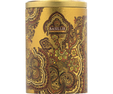 Detal puszki Basilur Golden Crescent z orientalnym wzorem w kolorze złota i zieleni.