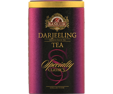 Bok puszki Basilur Darjeeling z logo i złotymi detalami.