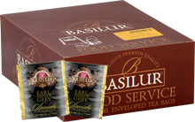 Opakowanie herbaty Basilur Earl Grey z widocznymi saszetkami czarnej herbaty cejlońskiej z aromatem bergamotki.