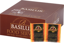 Opakowanie herbaty Basilur Ceylon Premium z widocznymi saszetkami czarnej herbaty cejlońskiej.