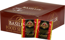 Opakowanie herbaty Basilur English Breakfast z widocznymi saszetkami czarnej herbaty cejlońskiej w czerwonych kopertach.