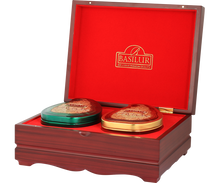 Zestaw herbat Basilur Island of Tea – puszki w kształcie serca w kolorze zielonym i złotym w drewnianym pudełku.