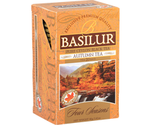 Opakowanie herbaty Basilur Autumn Tea w pomarańczowym kolorze z górskim motywem.