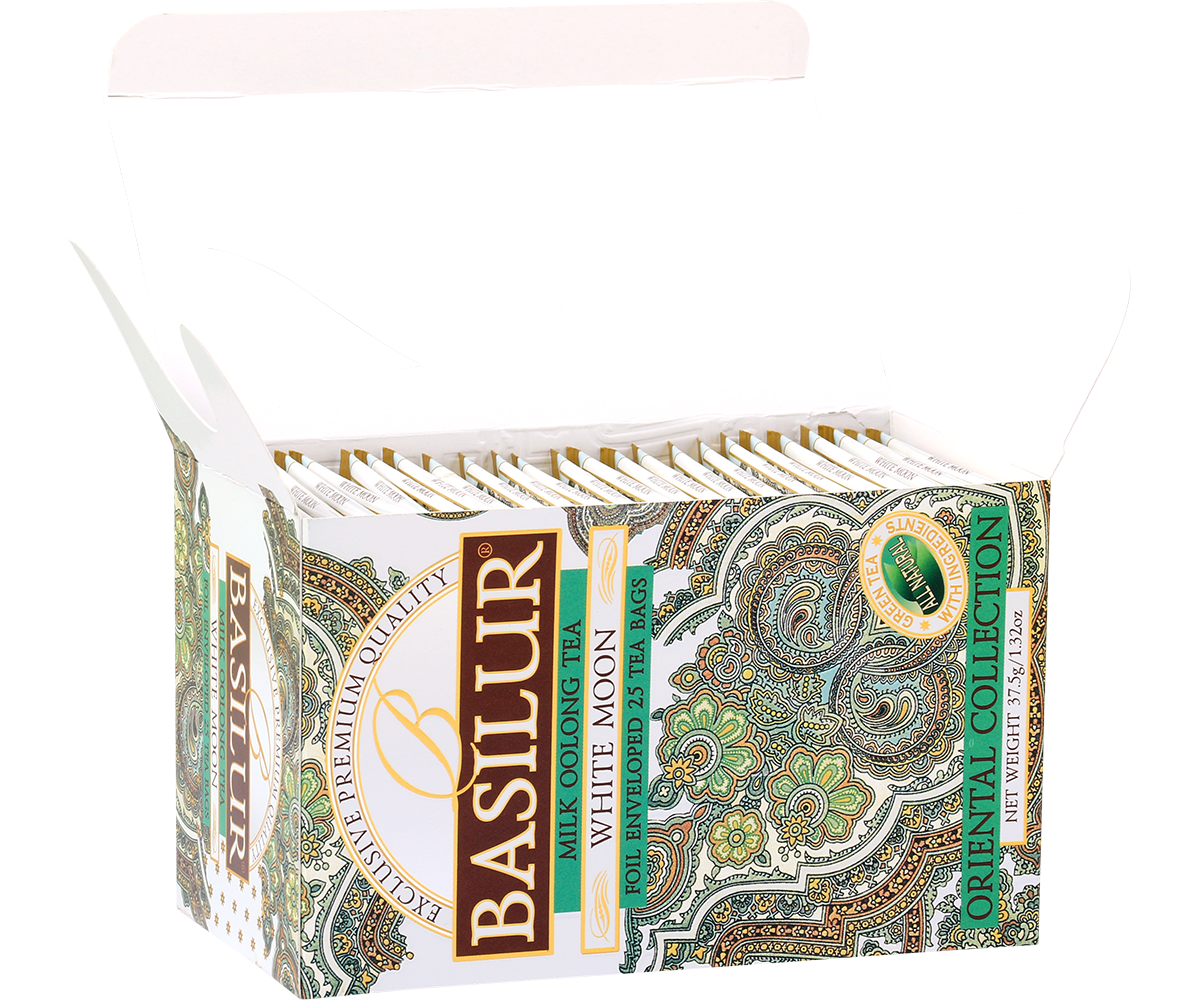 Otwarte pudełko herbaty Basilur White Moon z foliowanymi saszetkami mlecznej herbaty oolong.