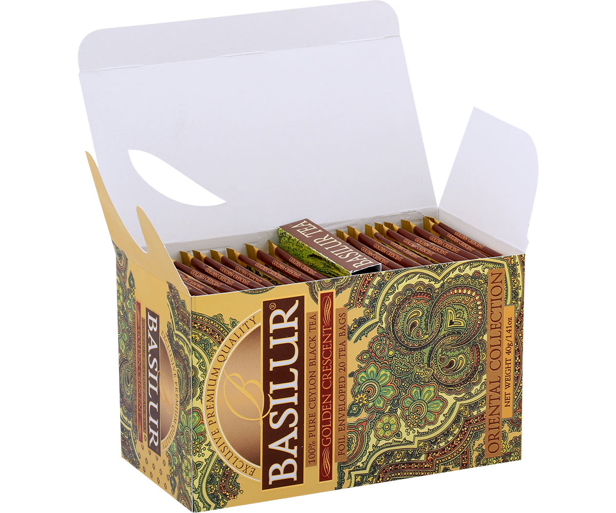 Otwarta herbata Basilur Golden Crescent z widocznymi kopertami zapakowanymi w ozdobne pudełko.