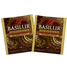 Dwie koperty foliowe Basilur Orient Delight z brązowo-złotym wzorem orientalnym.