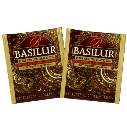 Dwie koperty foliowe Basilur Orient Delight z brązowo-złotym wzorem orientalnym.