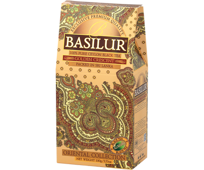Herbata Basilur Golden Crescent w złotym pudełku z detalami w odcieniach zieleni i czerwieni.