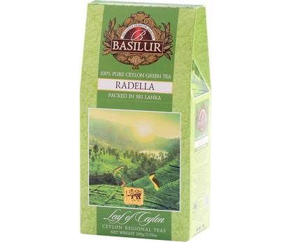 Zielone opakowanie herbaty Basilur Radella Green z górskim krajobrazem Cejlonu.