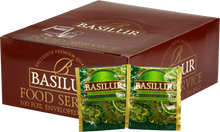 Opakowanie herbaty Basilur Moroccan Mint z widocznymi saszetkami zielonej herbaty cejlońskiej z miętą w zielonych kopertach z orientalnym wzorem.