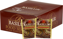 Opakowanie herbaty Basilur Orient Delight z widocznymi saszetkami czarnej herbaty cejlońskiej z orientalnej kolekcji w brązowo-złotych kopertach z ornamentem.