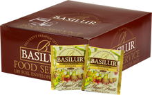 Opakowanie herbaty Basilur Ginger z widocznymi saszetkami czarnej herbaty cejlońskiej z imbirem.