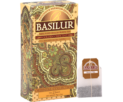 Pudełko Basilur Golden Crescent wraz z torebką herbaty z logo marki.