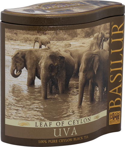 Metalowa puszka herbaty Basilur Uva z motywem słoni w rzece.