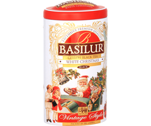 Puszka herbaty Basilur White Christmas z czerwonym wieczkiem i ilustracją bożonarodzeniową.