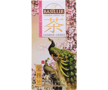 Front opakowania Basilur Jasmine Green z motywem pawia i kwitnących drzew wiśni.