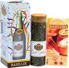 Zestaw Basilur Gold Splash – szklana tuba z herbatą i saszetkami do parzenia.