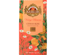 Herbata Basilur Citrus Bliss z kolekcji Vintage Blossoms w ozdobnym pomarańczowym opakowaniu z motywem cytrusów i rumianku.