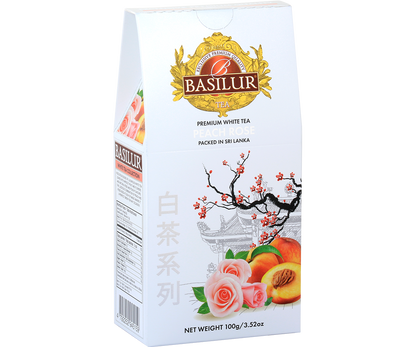 Opakowanie herbaty Basilur Peach Rose 100 g z motywem róż i brzoskwiń – elegancka biała herbata premium.
