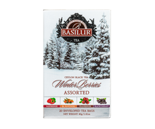 Herbata Basilur Winter Berries w zimowym opakowaniu z ilustracją ośnieżonych drzew.