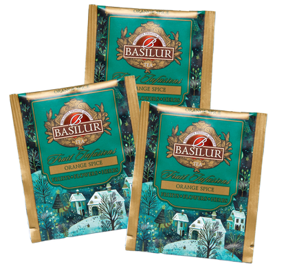 Saszetki herbaty Basilur Orange Spice z ilustracją zimowej wioski.