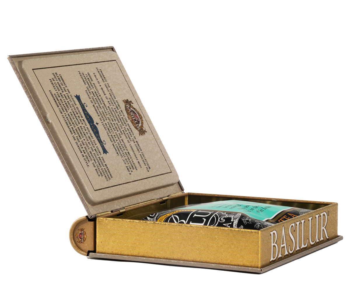 Otwarta puszka Basilur w formie książki z widoczną torebką herbaty w środku