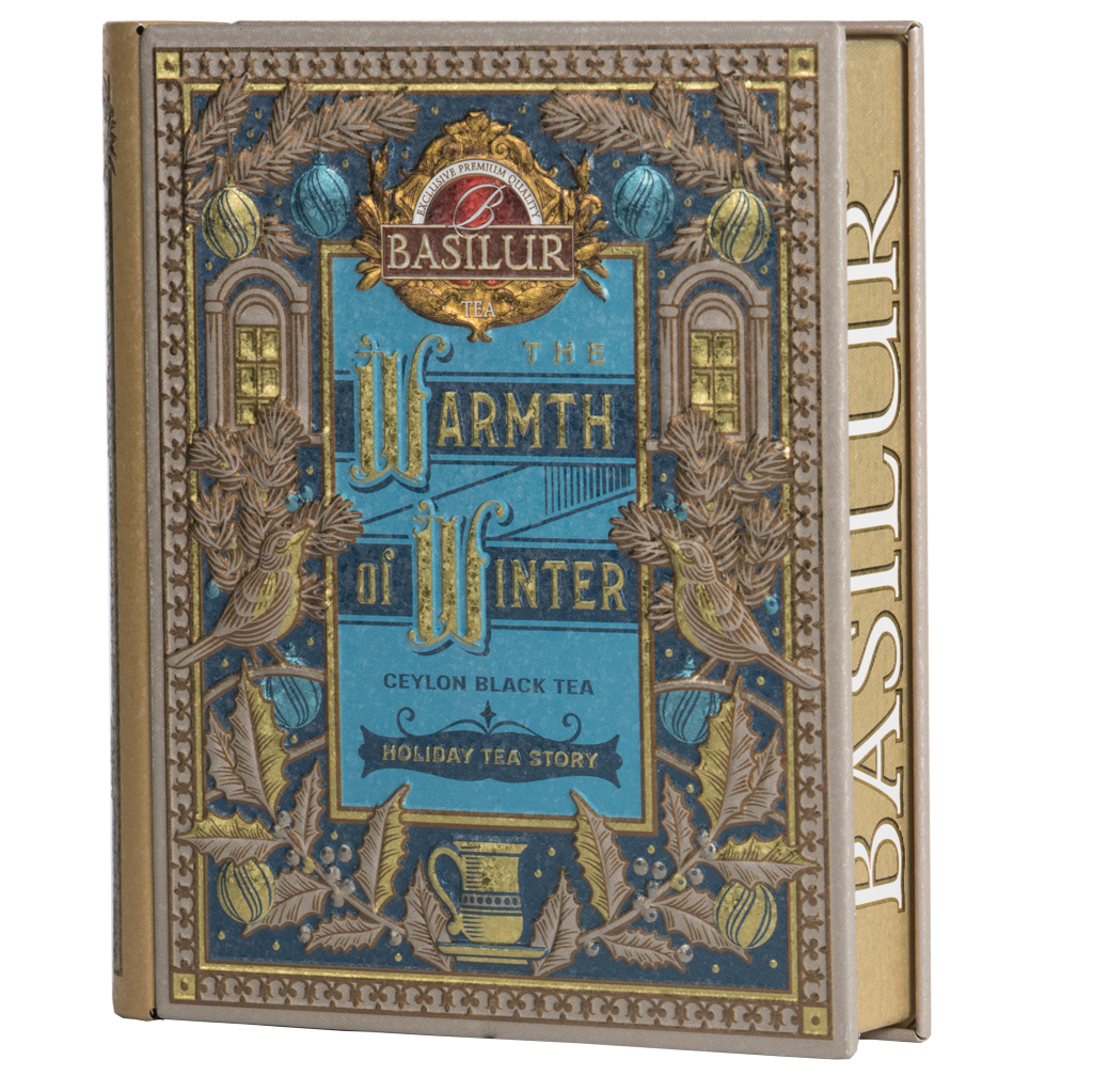 Herbata Basilur Warmth of Winter vol. II w puszce w kształcie książki z błękitno-złotym zdobieniem.