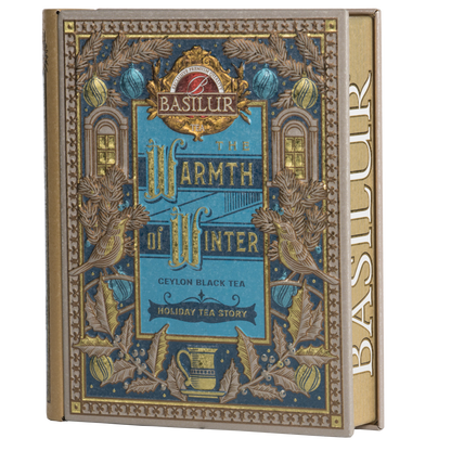 Herbata Basilur Warmth of Winter vol. II w puszce w kształcie książki z błękitno-złotym zdobieniem.