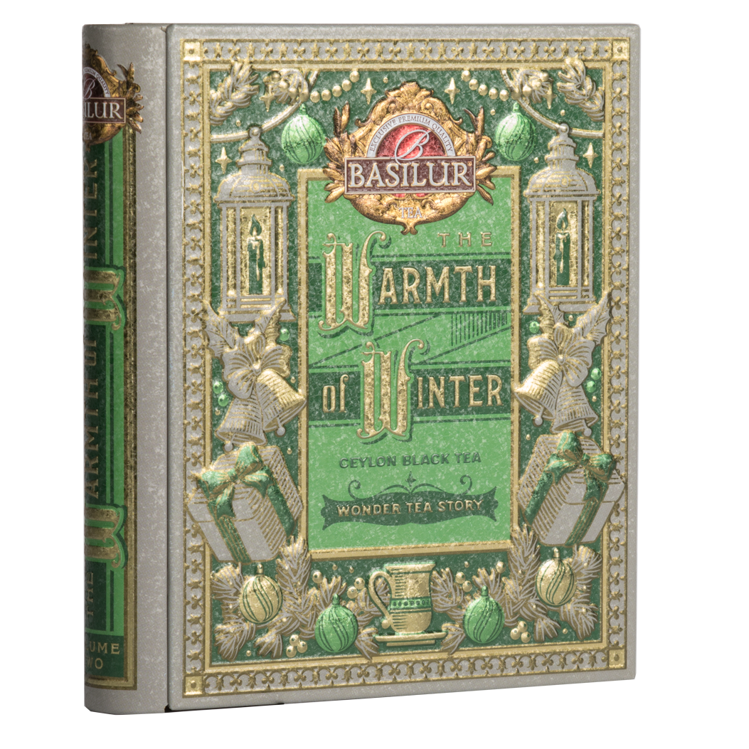 Puszka Basilur Wonder Tea Story w kształcie książki z zielono-złotym zdobieniem.