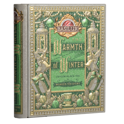Puszka Basilur Wonder Tea Story w kształcie książki z zielono-złotym zdobieniem.