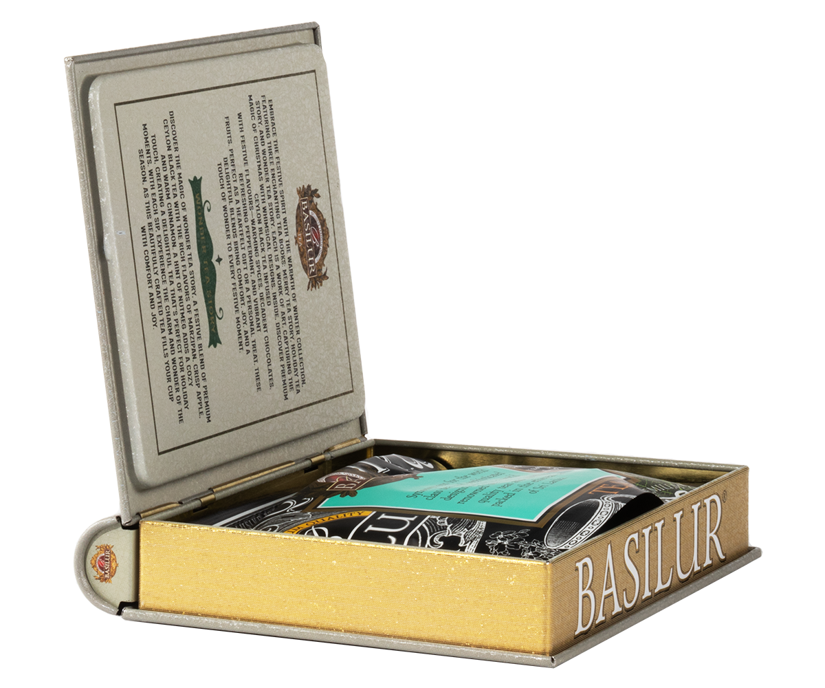 Otwarta puszka Basilur w formie książki z torebką herbaty w środku