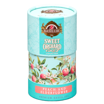 Dekoracyjna tuba herbaty zielonej Basilur Peach & Elderflower pokazana pod kątem, opakowanie prezentowe Basilur.