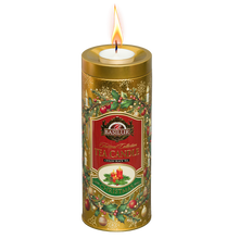 Herbata czarna Basilur Gold Edition w świątecznej złotej puszce z zapaloną świeczką tealight na wieczku.