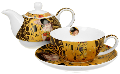 Filiżanka z dzbankiem ustawione razem na spodku w odcieniach złota i brązu.