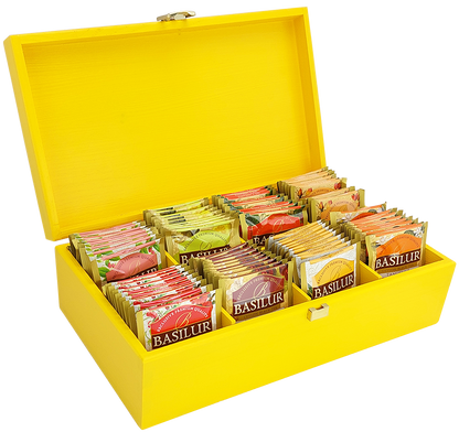 Żółty drewniany ekspozytor Basilur z 80 saszetkami herbaty premium w eleganckim pudełku.