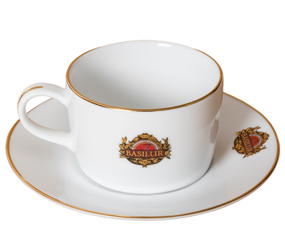 Filiżanka porcelanowa Basilur z uchwytem, zdobiona złotym rantem i logo.