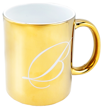 Elegancki kubek Basilur o złotym połysku z subtelnym grawerem, idealny do herbaty.