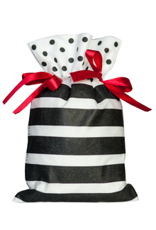 Biały worek prezentowy 30 x 45 cm w czarno-białe paski, przewiązany czerwonymi wstążkami i grochowym wykończeniem.