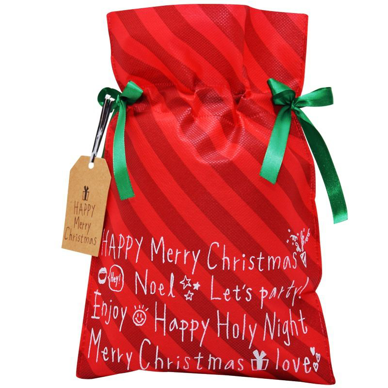 Duży czerwony worek prezentowy w paski z białymi napisami i zieloną wstążką.