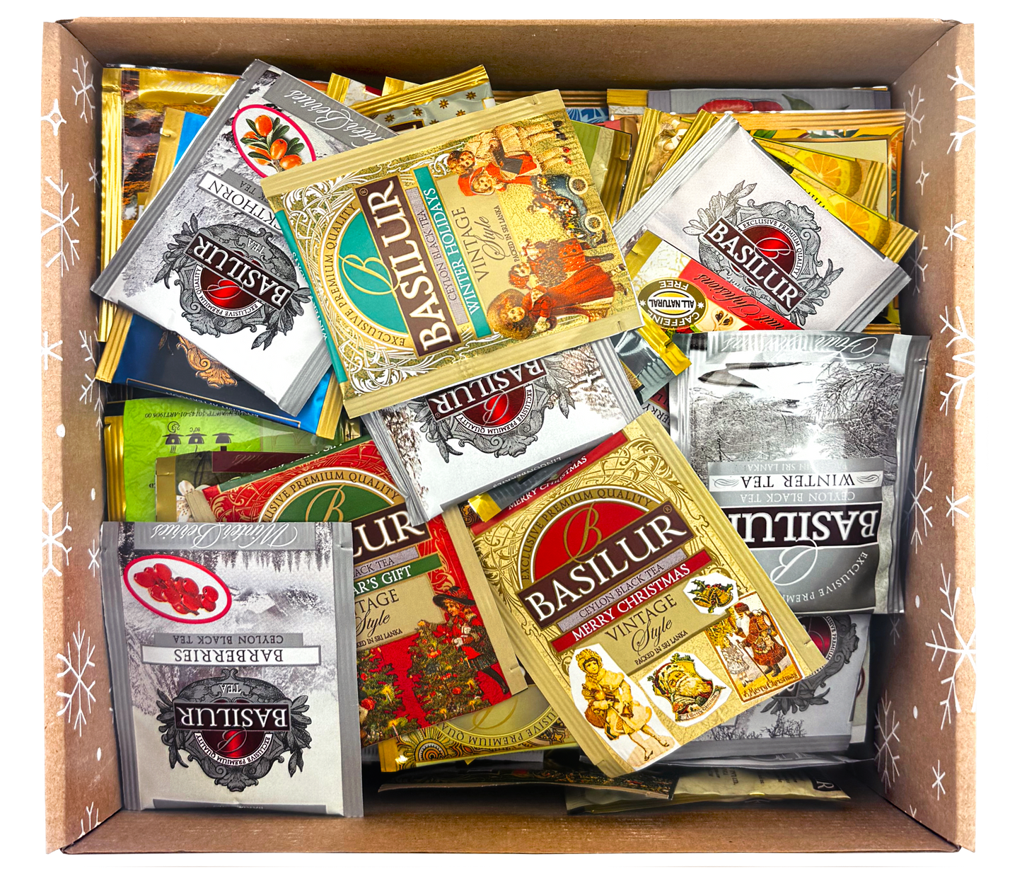 Wnętrze pudełka z herbatami Basilur, Tipson i Stassen w kolorowych kopertach.