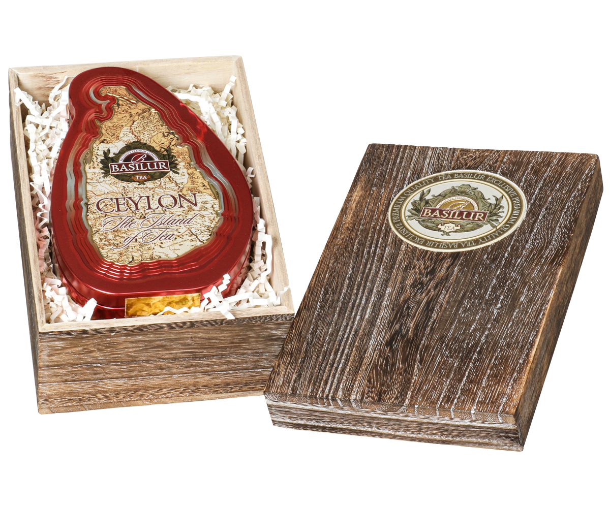 Otwarta skrzynka Basilur Crimson Paulownia z puszką w kształcie wyspy Sri Lanka.