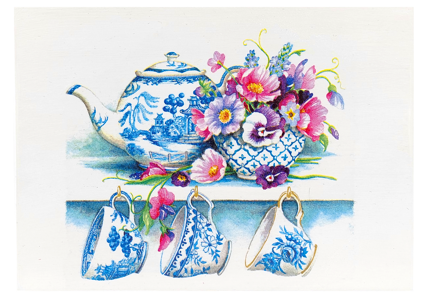 Pokrywa skrzynki Basilur Filiżanki z niebieską porcelaną i kwiatowym motywem.