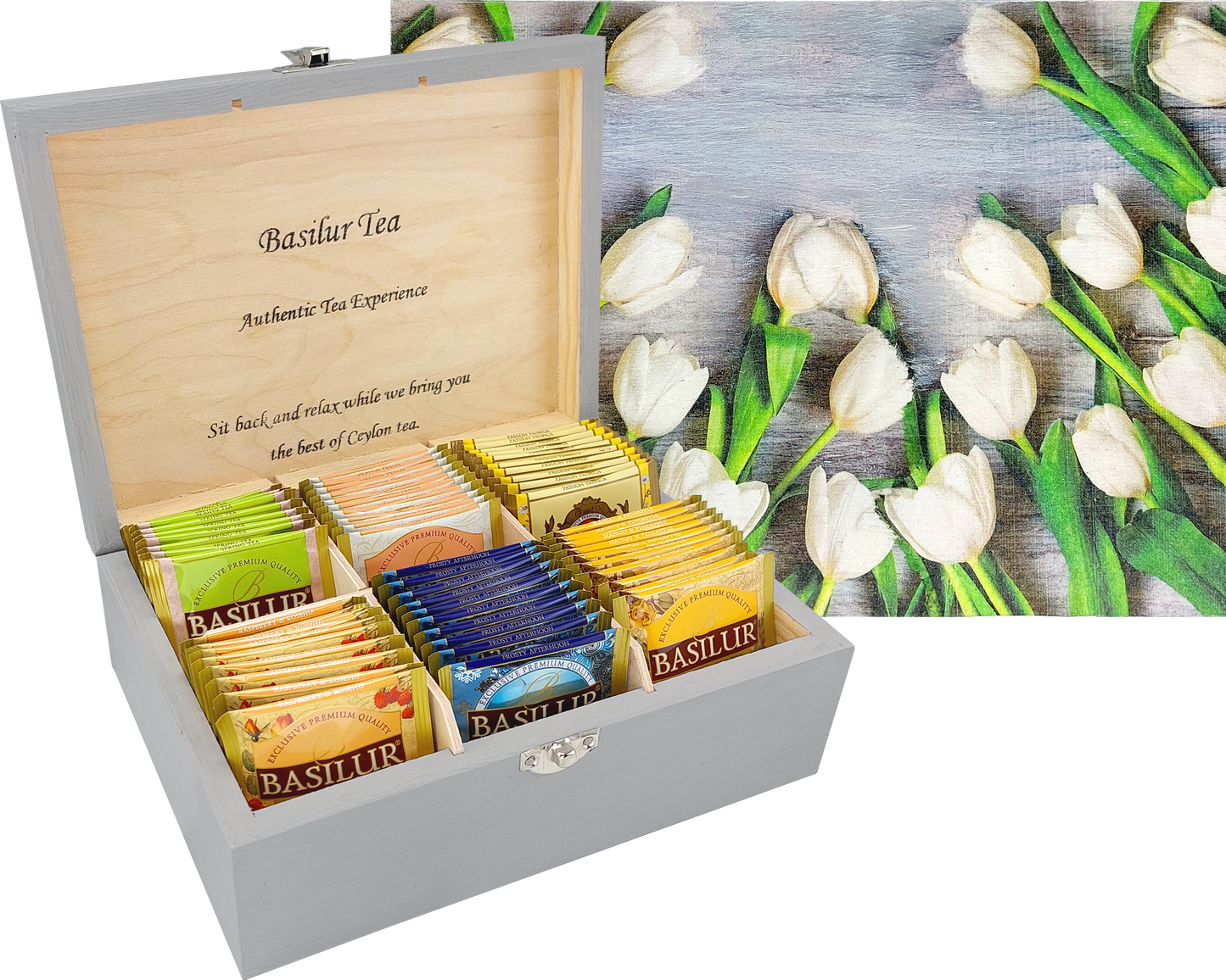 Otwarta skrzynka Basilur Białe Tulipany z kolorowymi herbatami i ozdobną pokrywą.